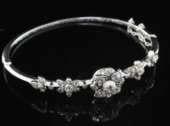 An early 20th century white gold and diamond hinged bangle, gross 12.2 grams.